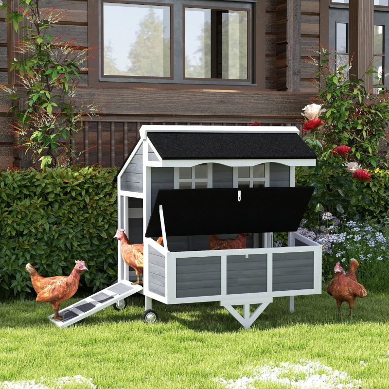 Chickens around the wheeled coop on grass
