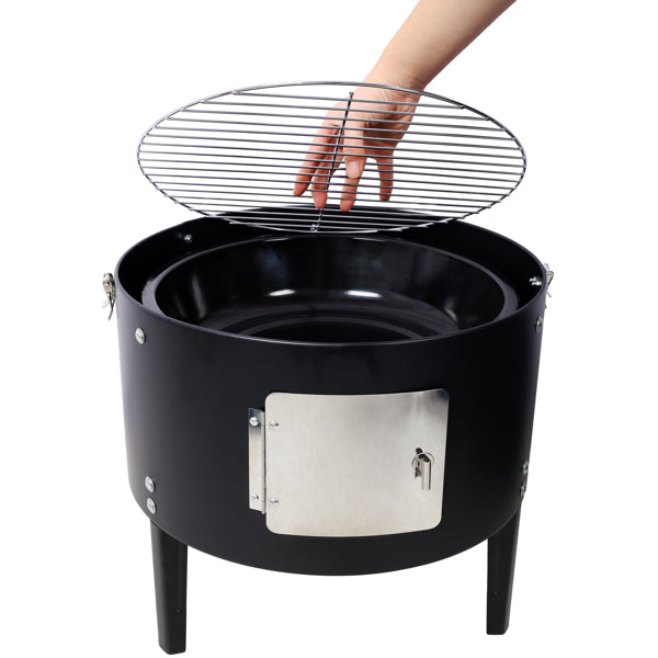 A hand lowering the round cooking grate into the top of the black smoker