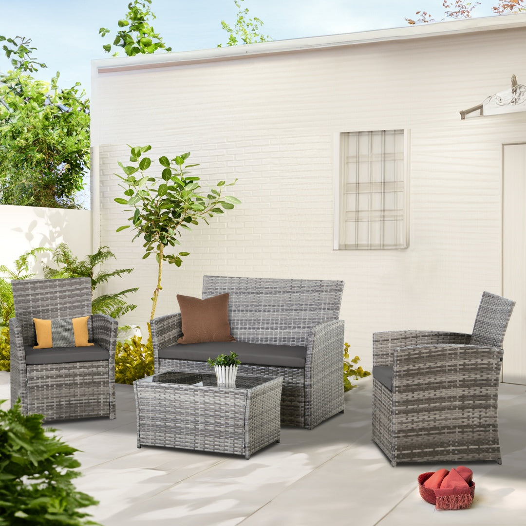 Rattan loveseat and chairs with glass coffee table