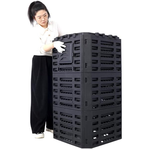 The compost bin beside a person, showing its height