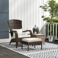Wicker Adirondack chair and ottoman on a covered porch