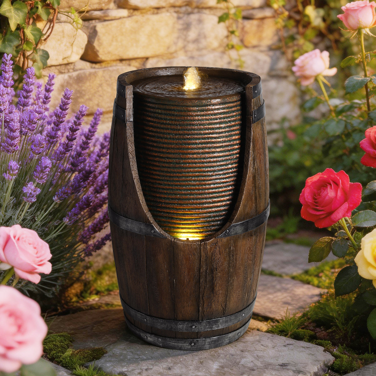 Barrel fountain surrounded by flowers