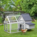 Gray and white chicken coop with run on grass