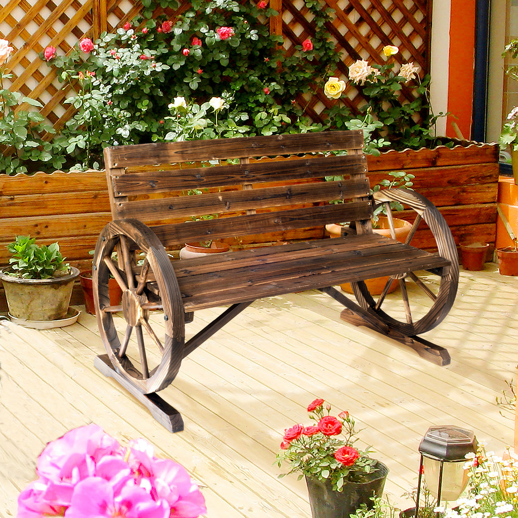 The carbonized bench beside a planter of flowers