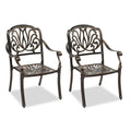 Two stackable cast aluminum patio chairs with armrests in antique bronze