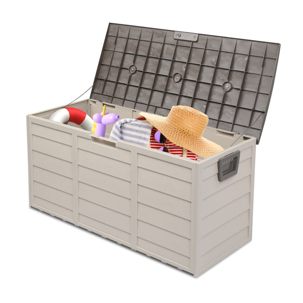 The deck box open with folded towels and a straw sun hat inside