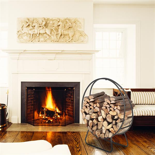 The rack full of logs next to a lit fire in a white mantel fireplace, on a dark wood floor