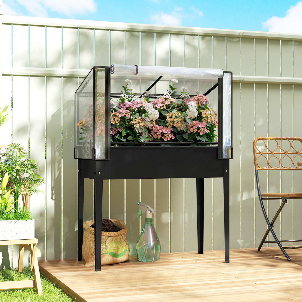 Elevated raised bed with its cold frame cover, planted and standing on a deck