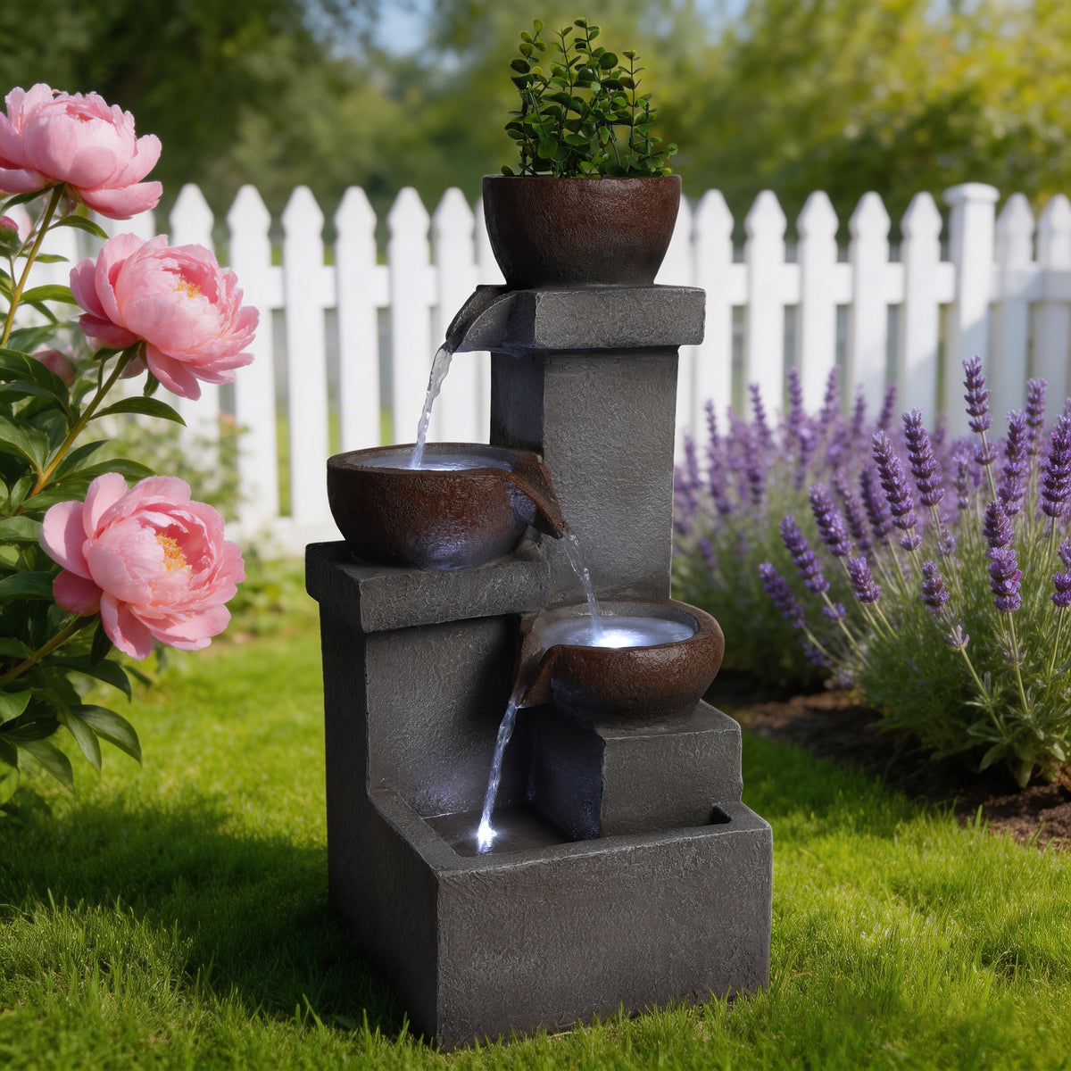 Tiered jar fountain running beside a flower border