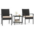 Three-piece black wicker bistro set with beige cushions and two-tier glass side table