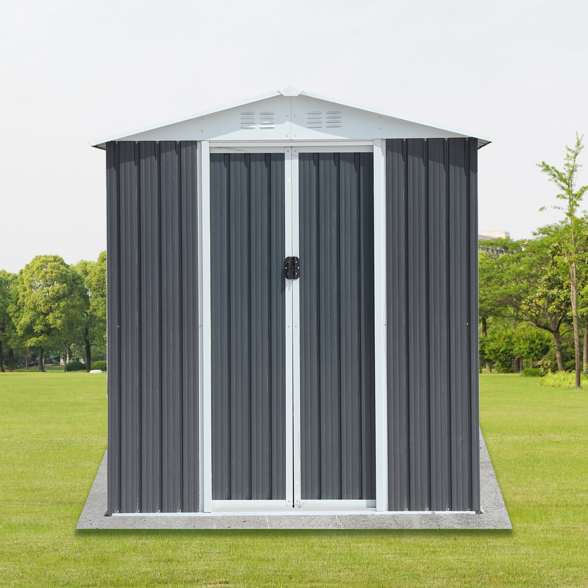 Front view of the grey shed on grass showing the double sliding doors and peaked roof