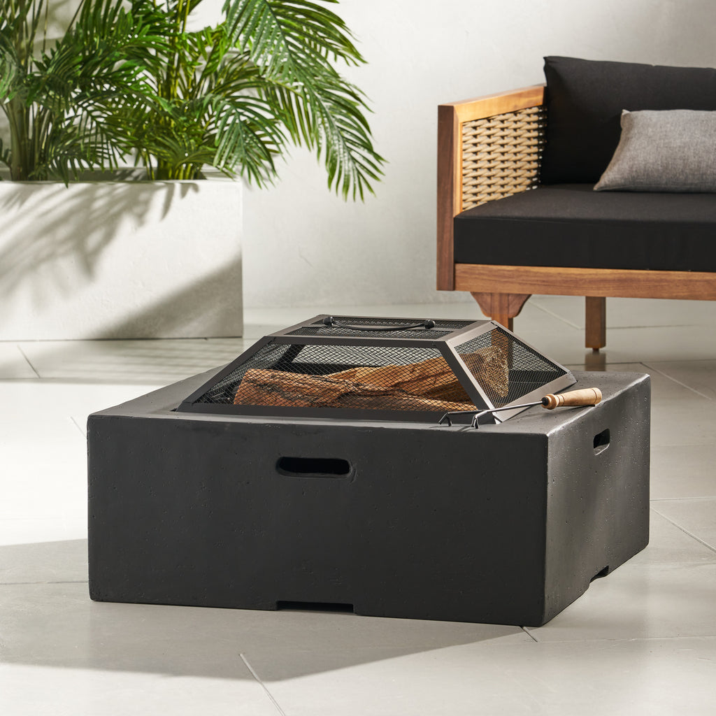 A dark grey square magnesium oxide fire pit on a patio