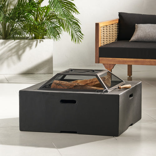 A dark grey square magnesium oxide fire pit on a patio