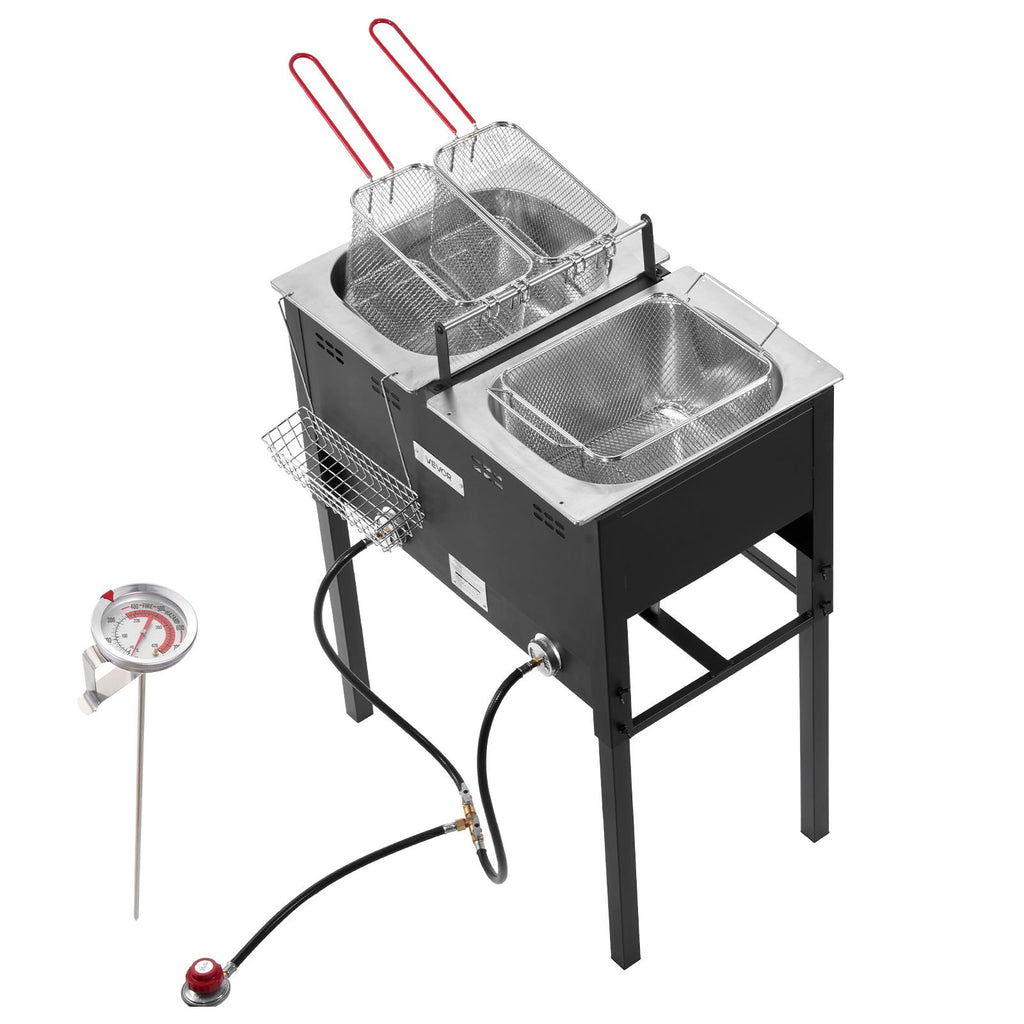 Three-quarter view of the fryer with the included clip-on oil thermometer standing beside it