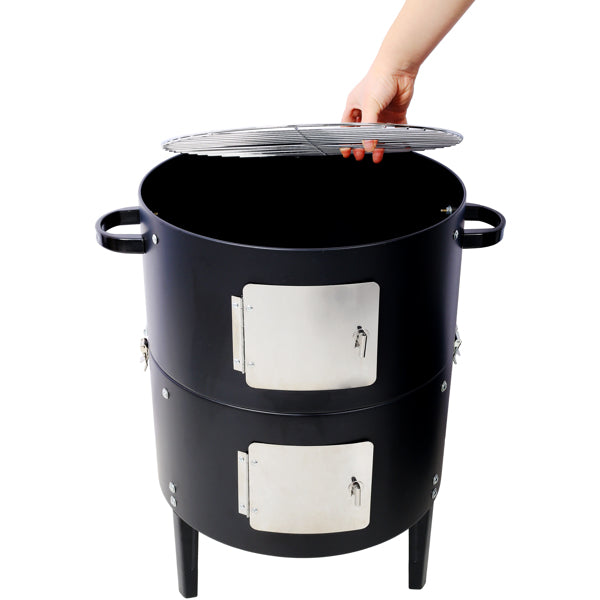 A hand lifting the lid off the smoker, showing the two stainless access doors