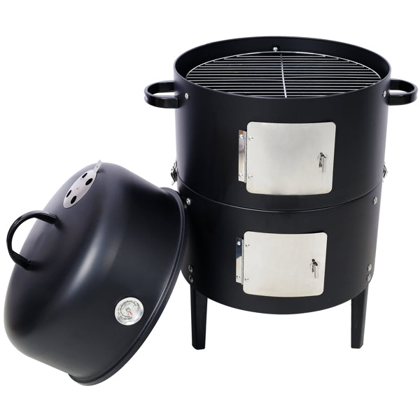 The smoker with its dome lid set on the ground beside it, cooking grate visible on top