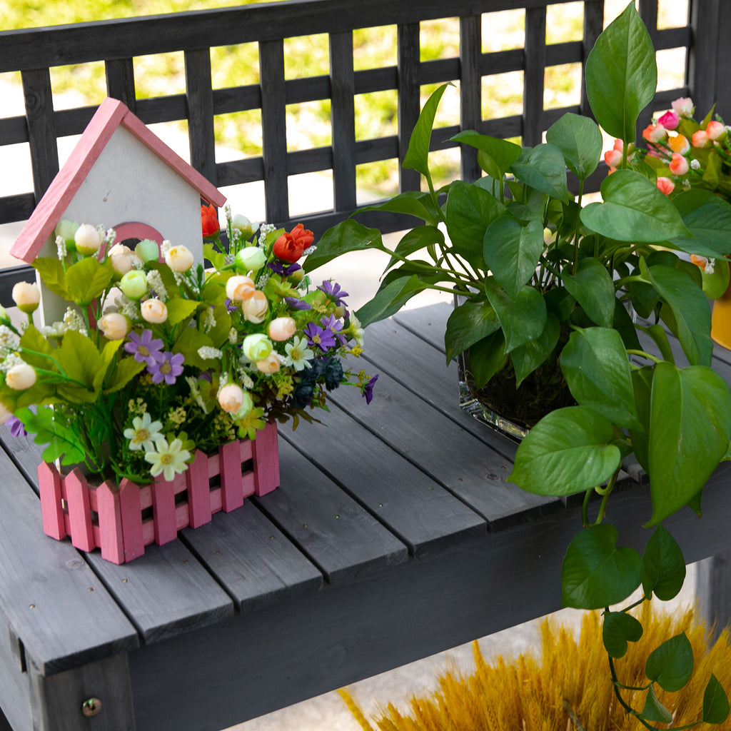 The bench loaded with pots and flowers