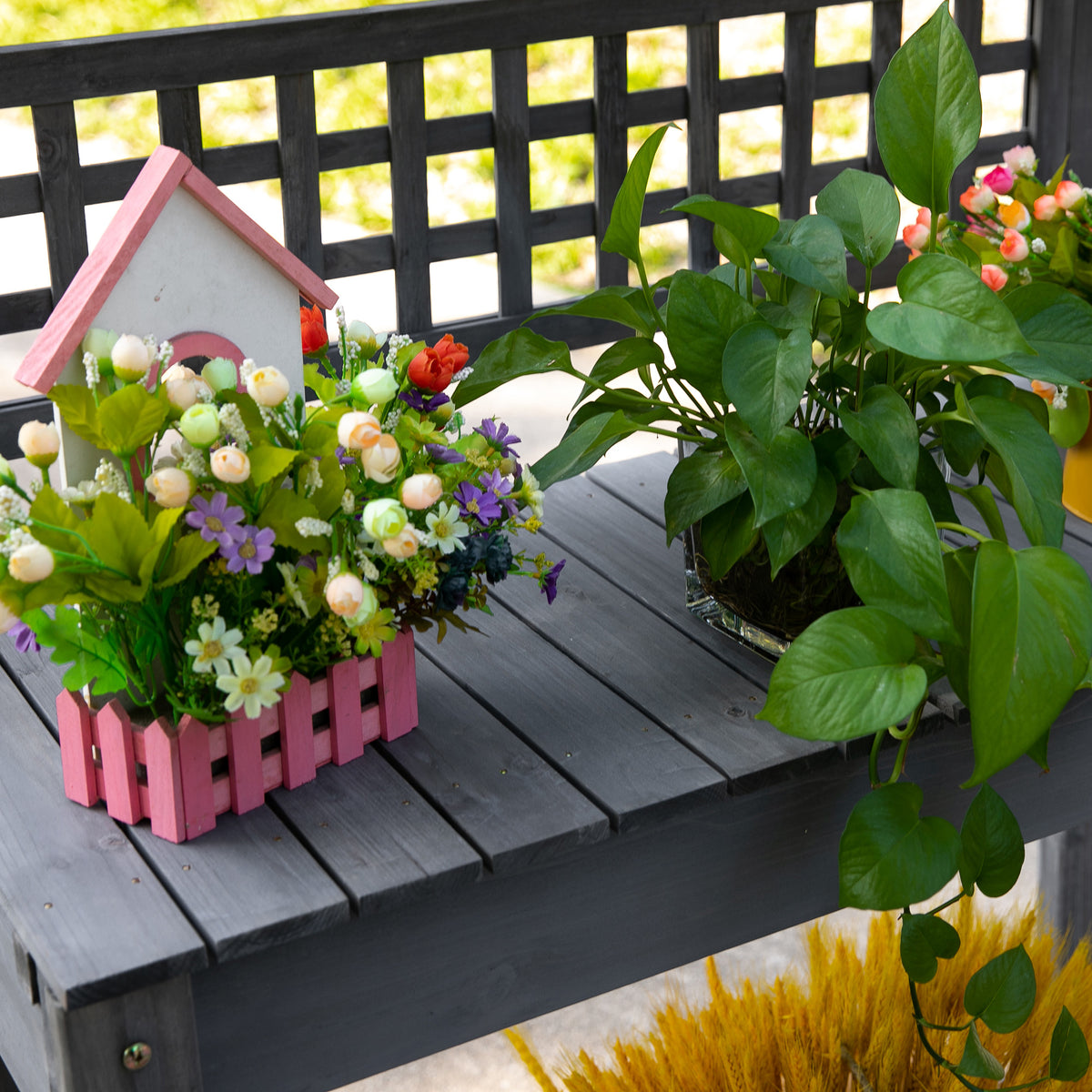 The bench loaded with pots and flowers