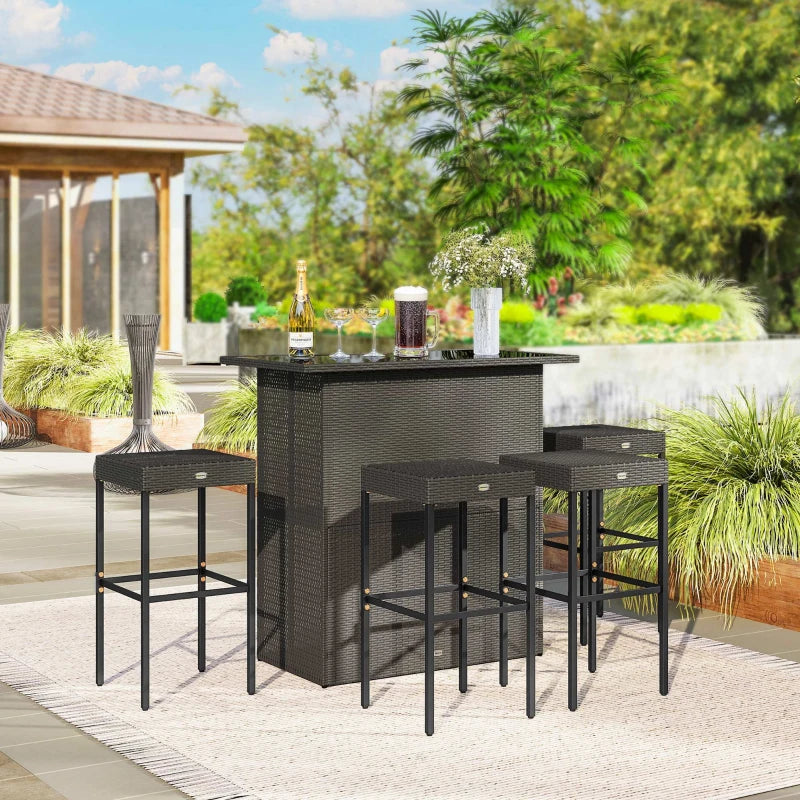 Bar set arranged on a backyard patio with drinks on the tabletop and plants behind