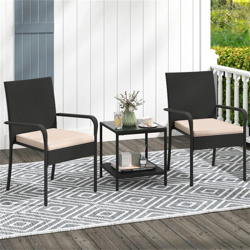 Wicker bistro set arranged on a patio with a rug and planter