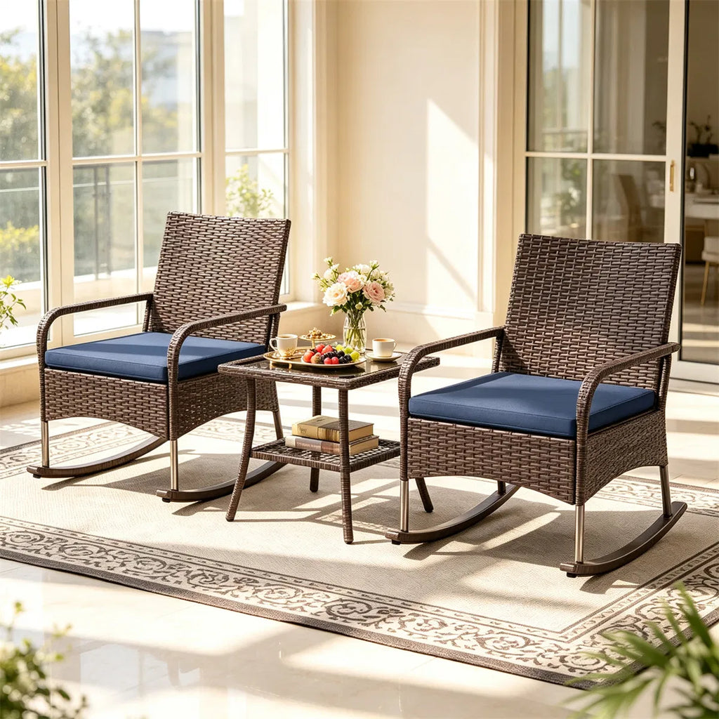 Wicker rocking chair set on a porch with a side table between the chairs