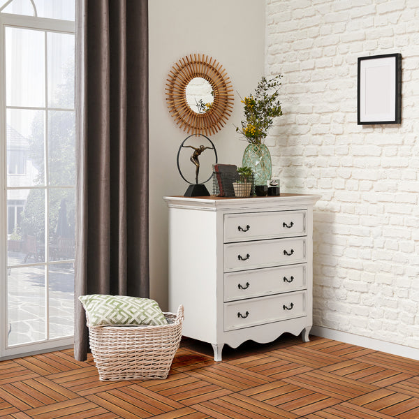 The tiles used indoors in a corner of a white brick room, with a painted chest of drawers, a round mirror and a woven basket