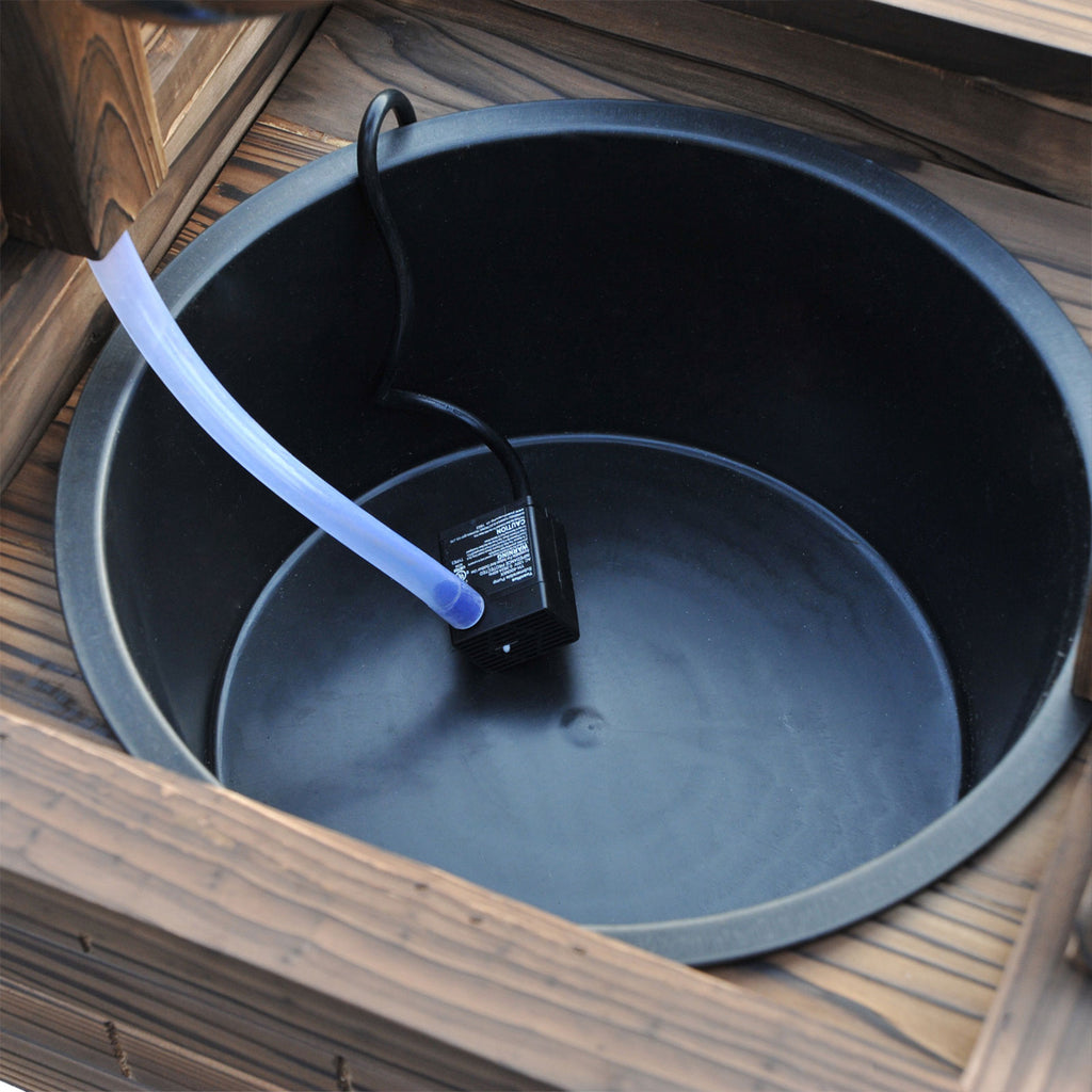 Lined basin inside the well box with the pump outlet