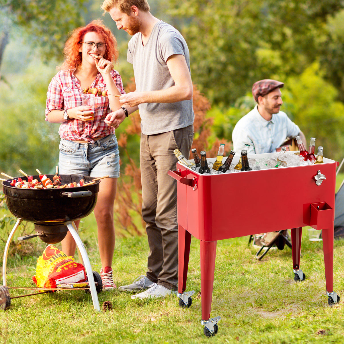 People helping themselves from the cooler cart beside a grill