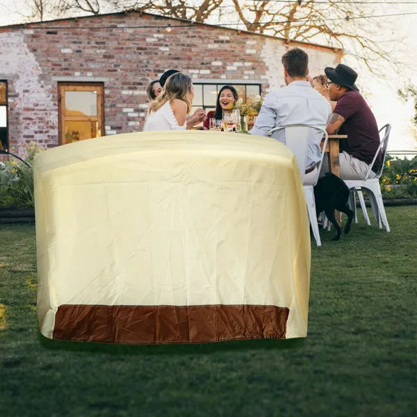 Covered grill on a patio beside an outdoor dining table