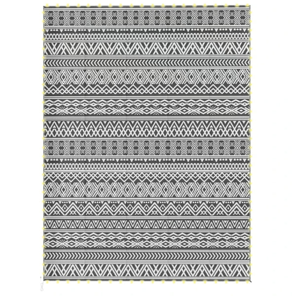 The rug laid flat on a white background showing its full black and white geometric pattern