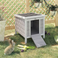 Elevated wooden rabbit hutch in a garden
