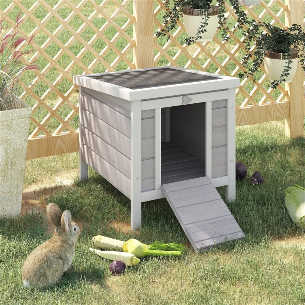 Elevated wooden rabbit hutch in a garden