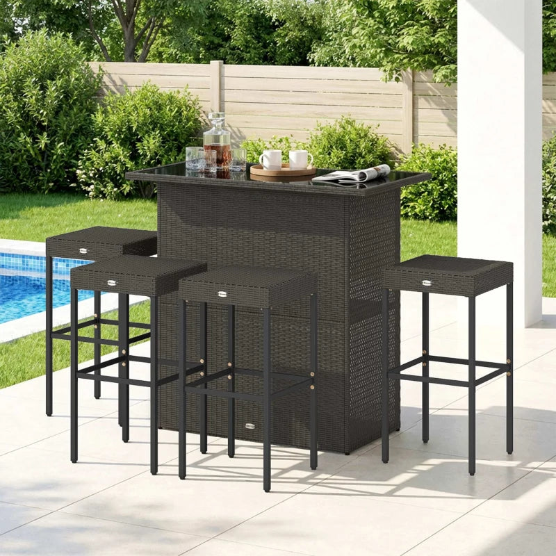Bar set on a poolside patio with bottles and glasses on the counter