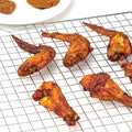 Wire cooling rack holding barbecue wings