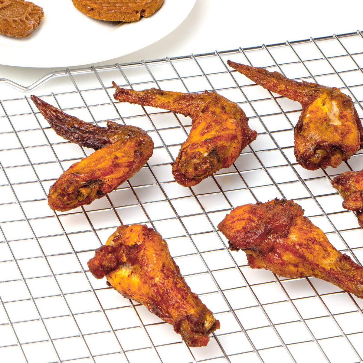 Wire cooling rack holding barbecue wings
