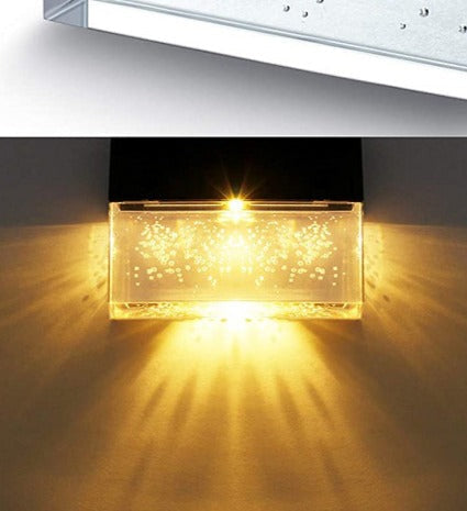Close-up of the bubble-glass lens throwing warm white light across a step
